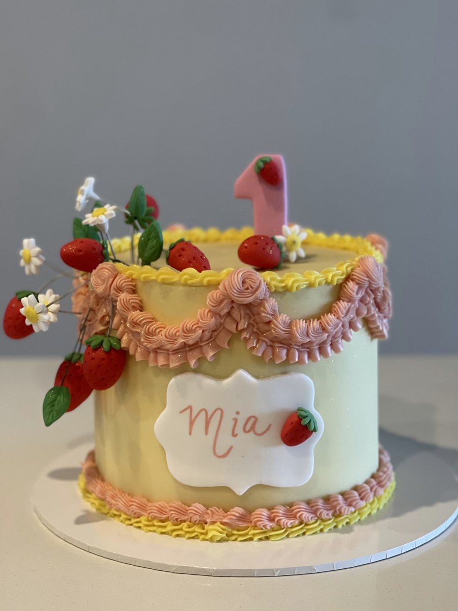 Vintage piped cake with strawberries and wildflowers